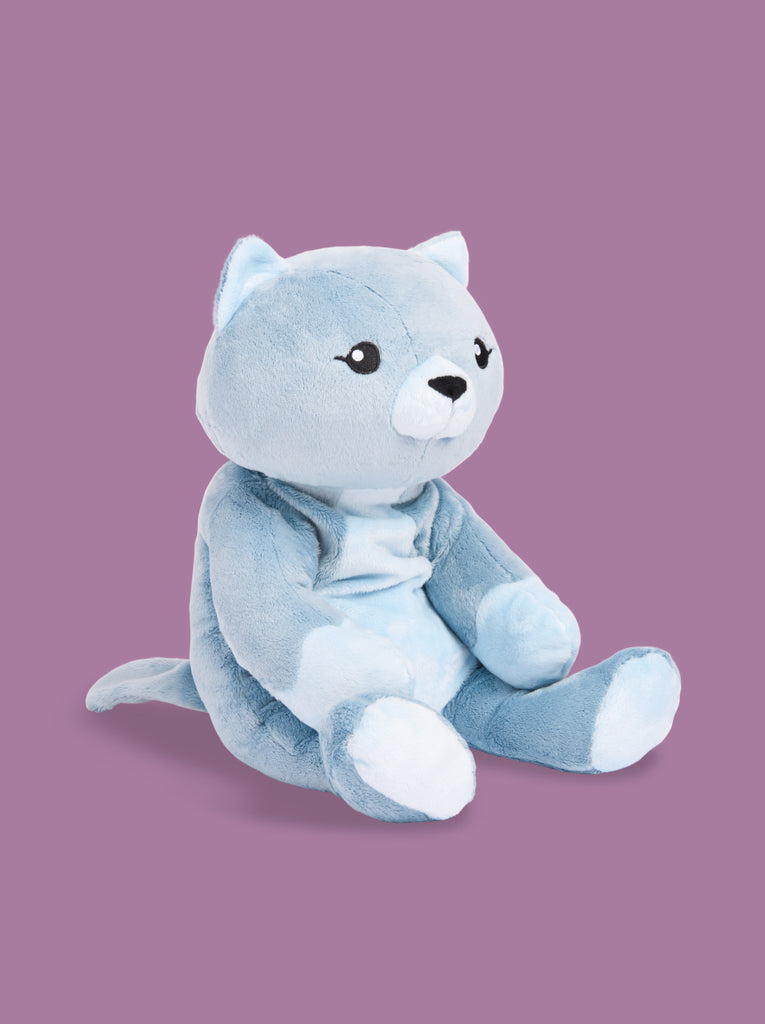 A blue cat stuffed animal sits facing right on a purple background