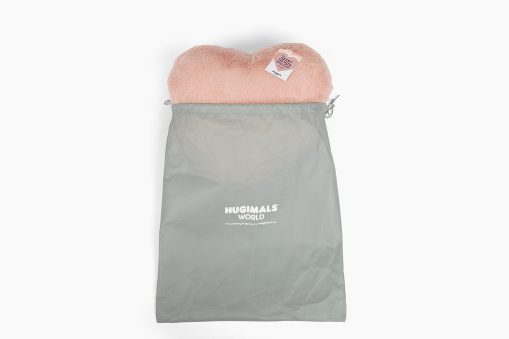 Image showing top of Antique Rose Super Sized Heart to Hug Pillow emerging from light gray branded Hugimals World gift bag
